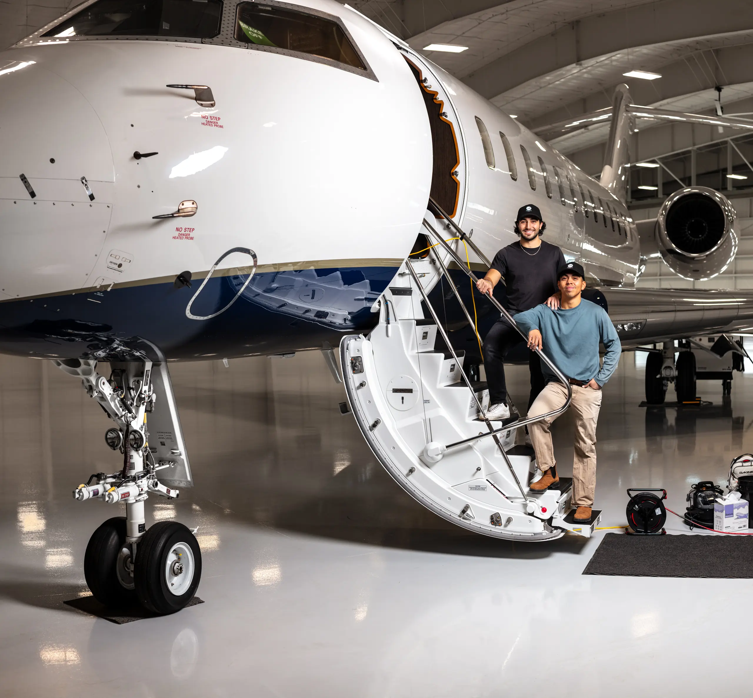 Aircraft detailers working on a private jet